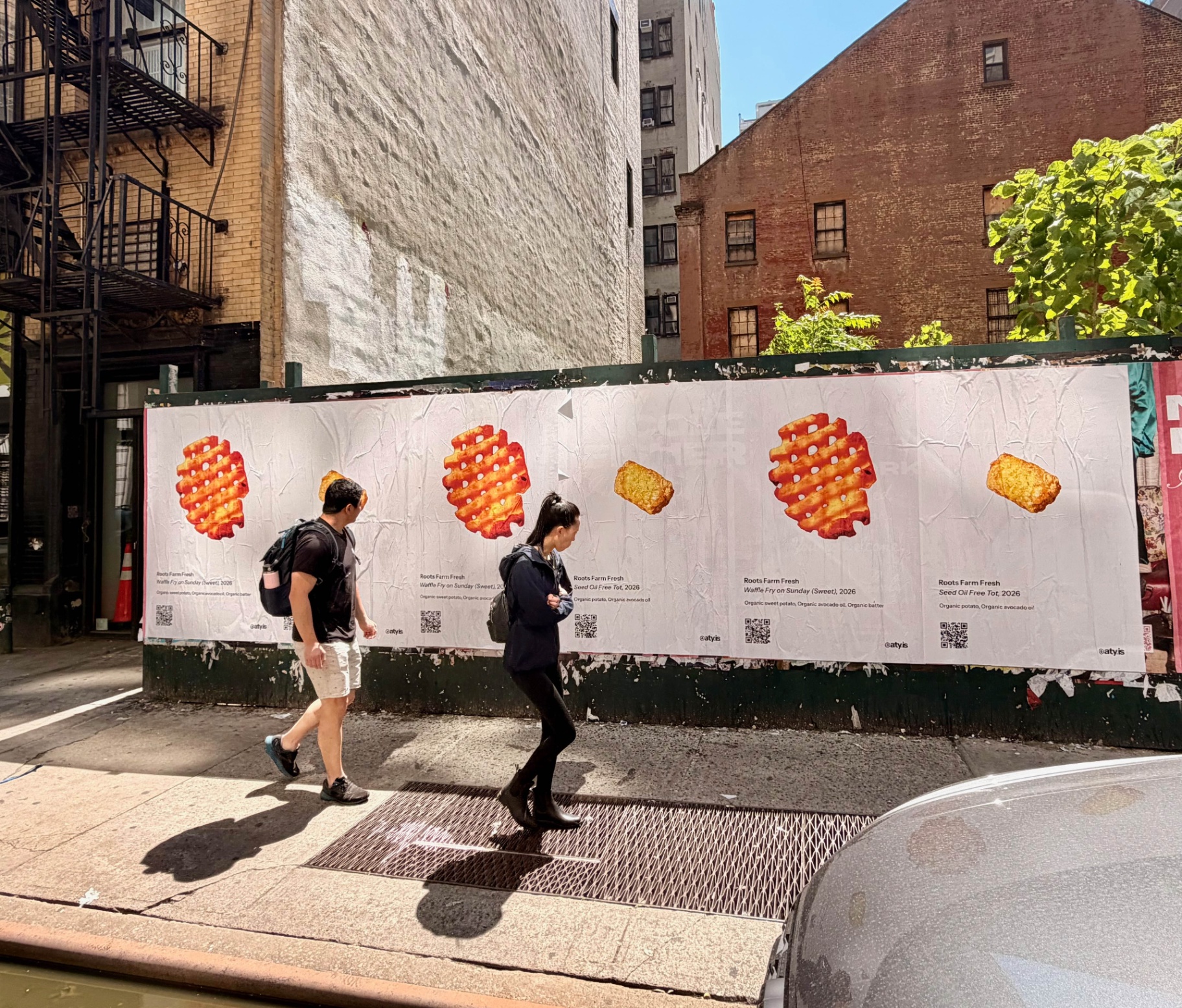 Long wheatpaste run of Roots Farm Fresh posters on a construction barrier